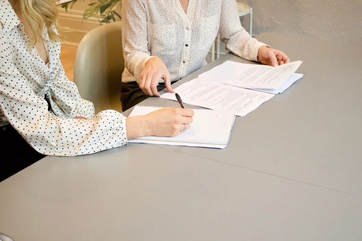 Two women reviewing legal documents during a consultation
